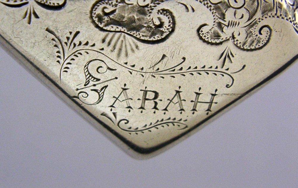 An engraved sterling silver Victorian vesta case featuring elaborate scrollwork detailing and the engraved name Sarah. View V