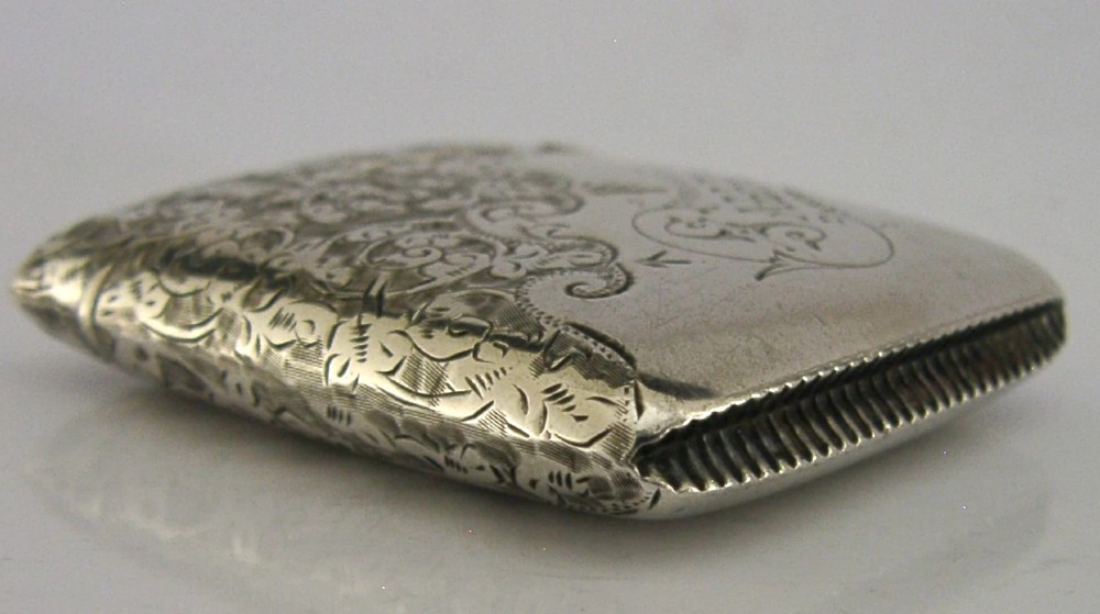 An engraved sterling silver Victorian vesta case featuring elaborate scrollwork detailing and the engraved name Sarah. View X