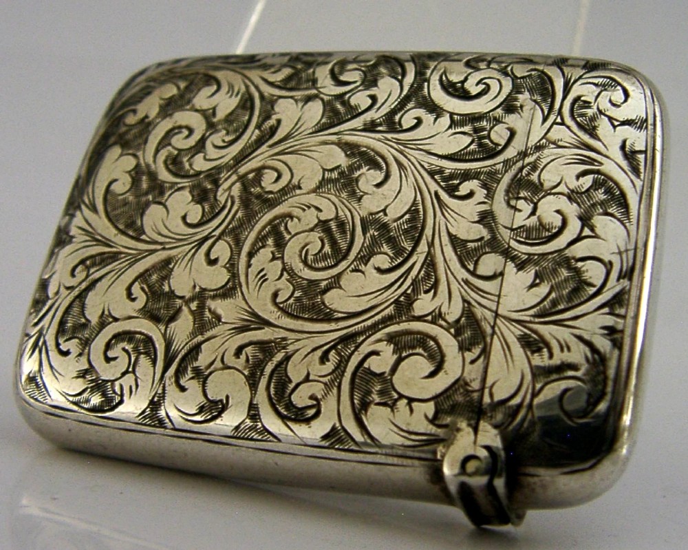 Victorian sterling silver vesta case decorated with hand-engraved foliate scrollwork and a central monogrammed shield cartouche. View IV