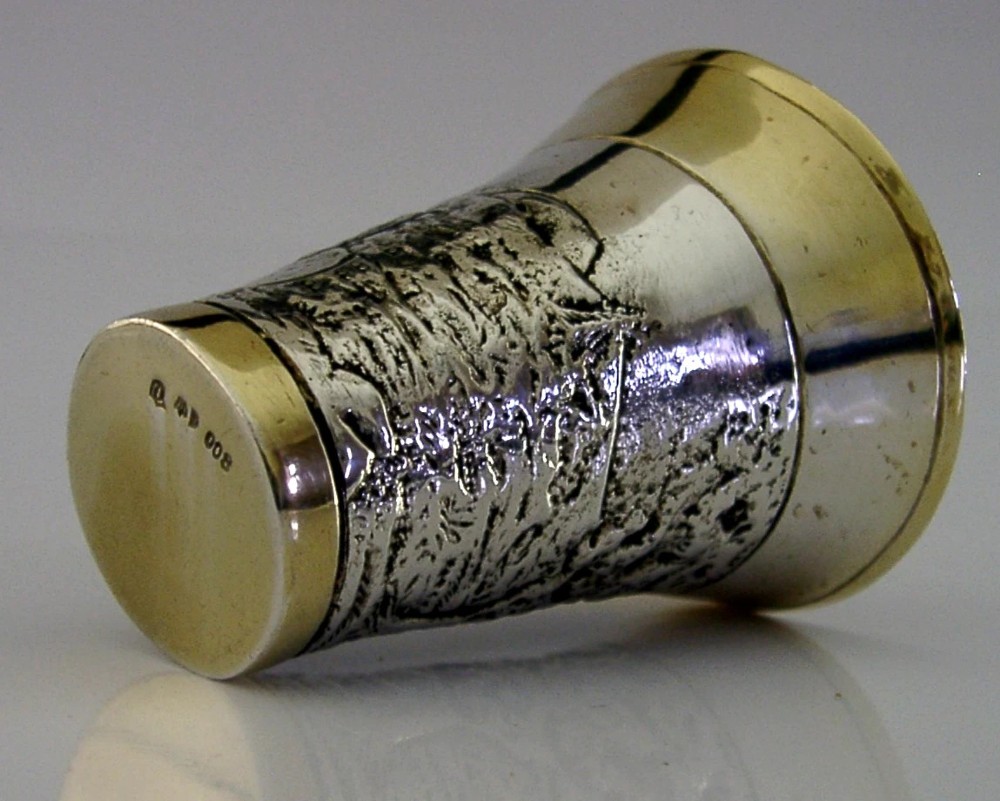 An antique 800 solid silver beaker with gilded rims featuring an embossed relief scene of a golfer. View VII
