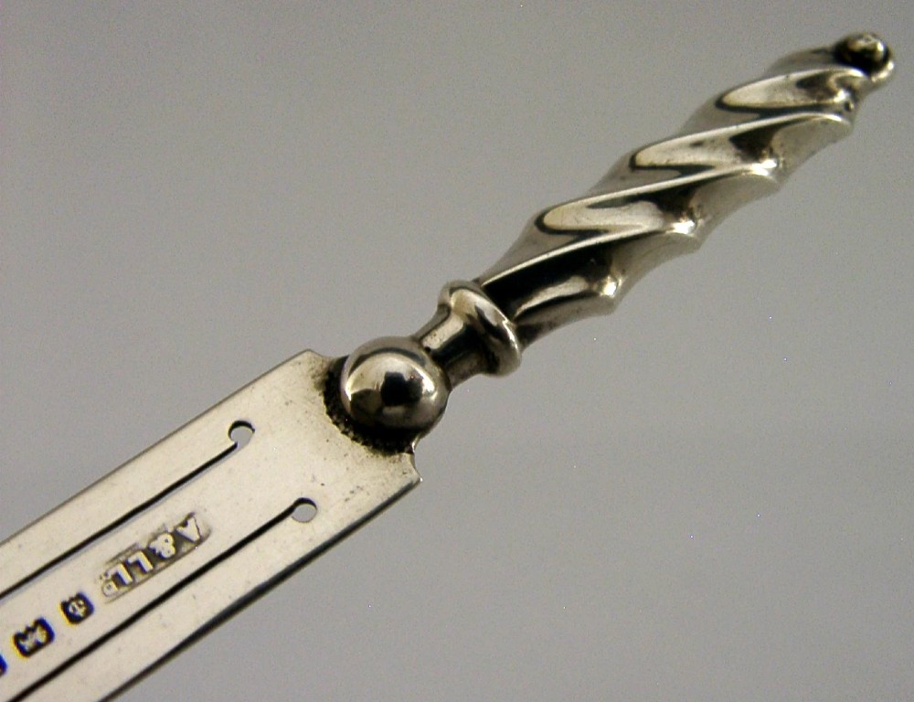 An antique sterling silver bookmark with a spiral twist handle and a flat page clip bearing English hallmarks. View II
