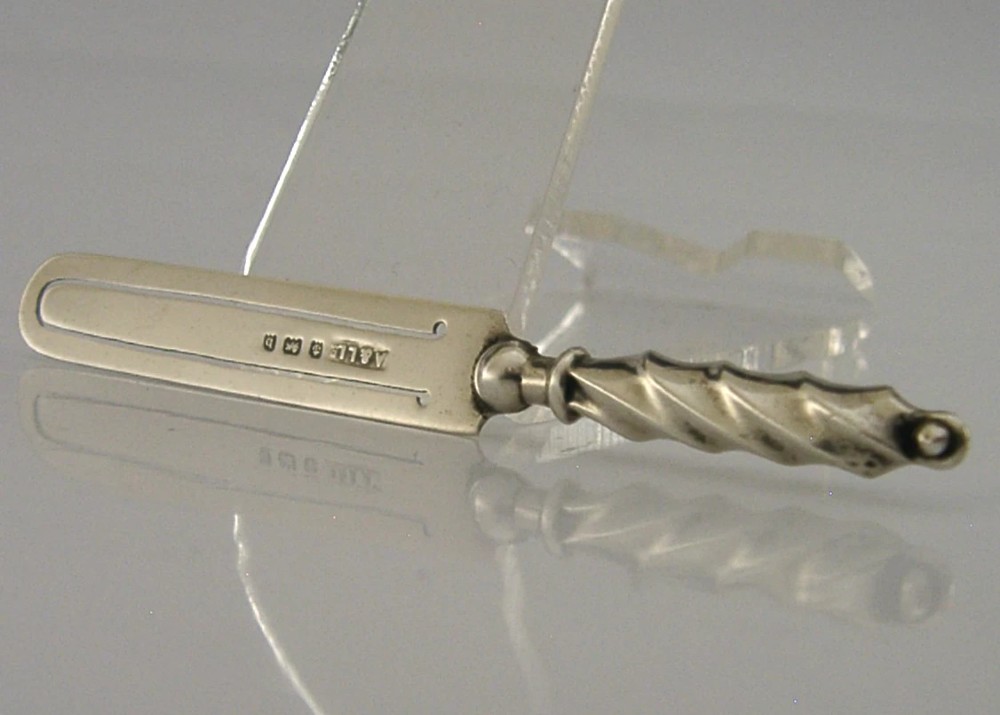 An antique sterling silver bookmark with a spiral twist handle and a flat page clip bearing English hallmarks. View III