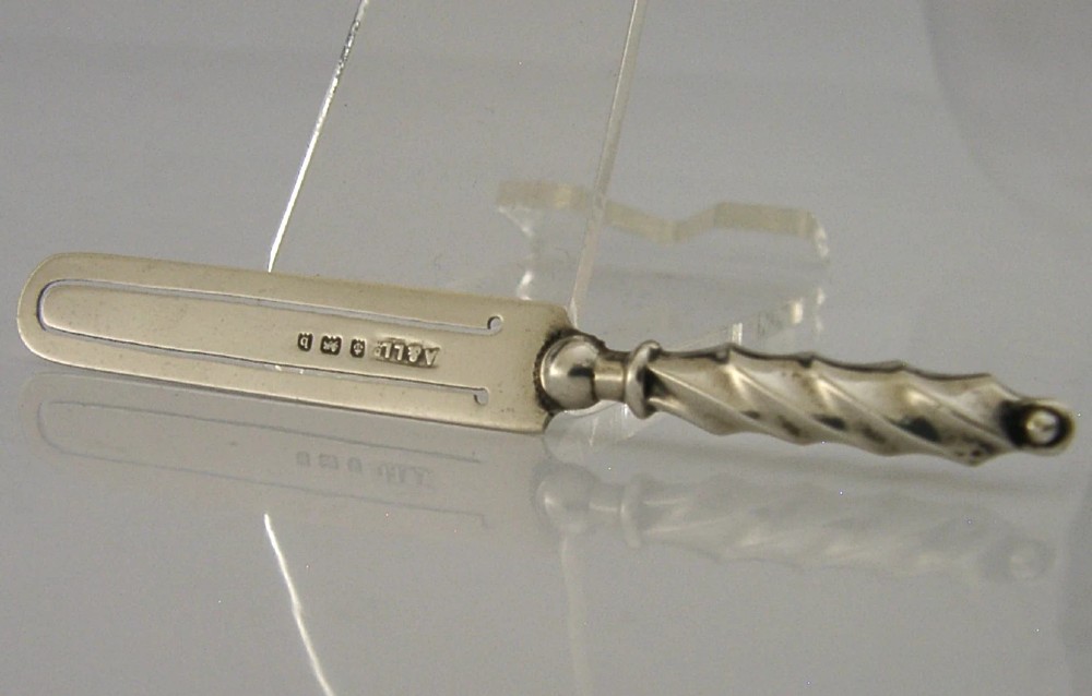 An antique sterling silver bookmark with a spiral twist handle and a flat page clip bearing English hallmarks. View V