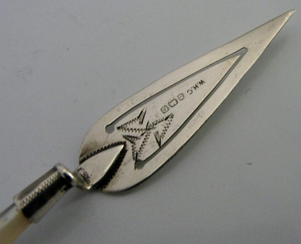 An Edwardian sterling silver bookmark with a tapered mother of pearl handle and an engraved silver clip bearing the Isle of Man triskelion emblem. View III