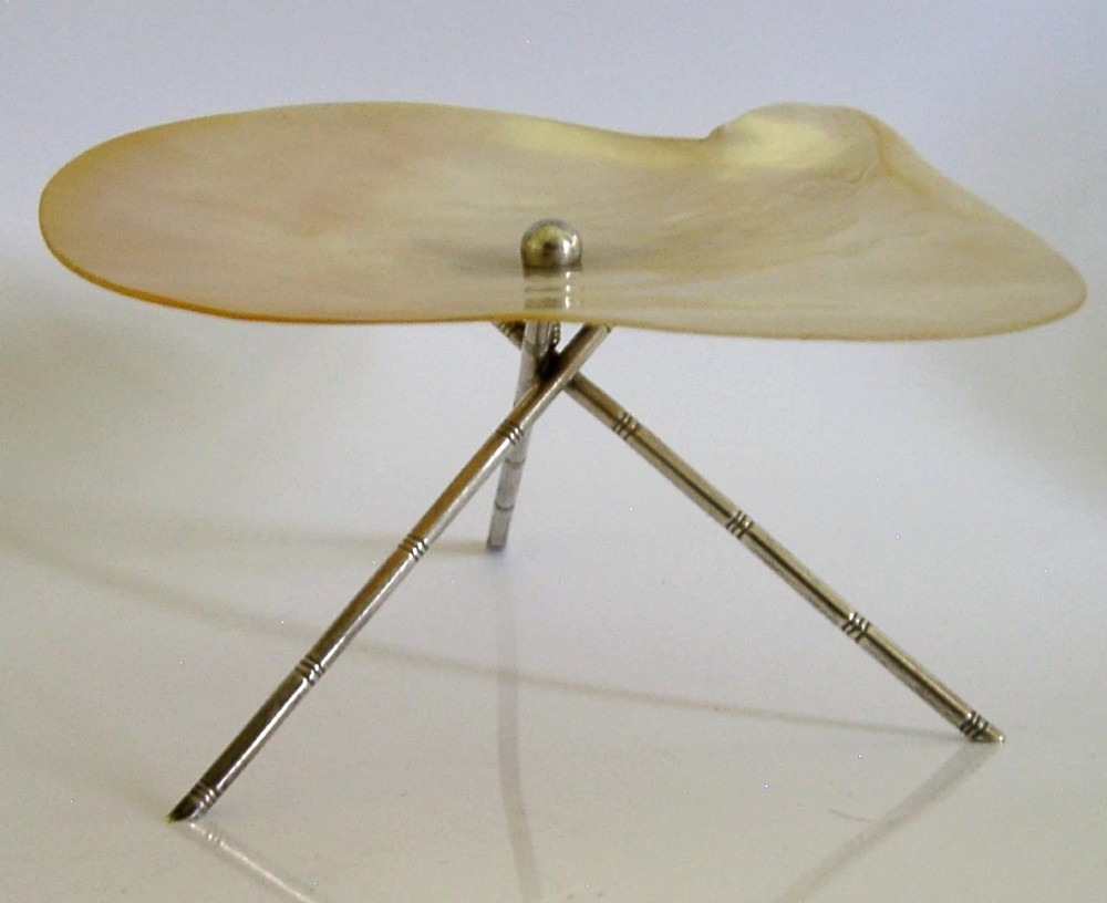 An antique mother-of-pearl shell dish supported on three slender silver tripod legs with a small central silver stud. View III
