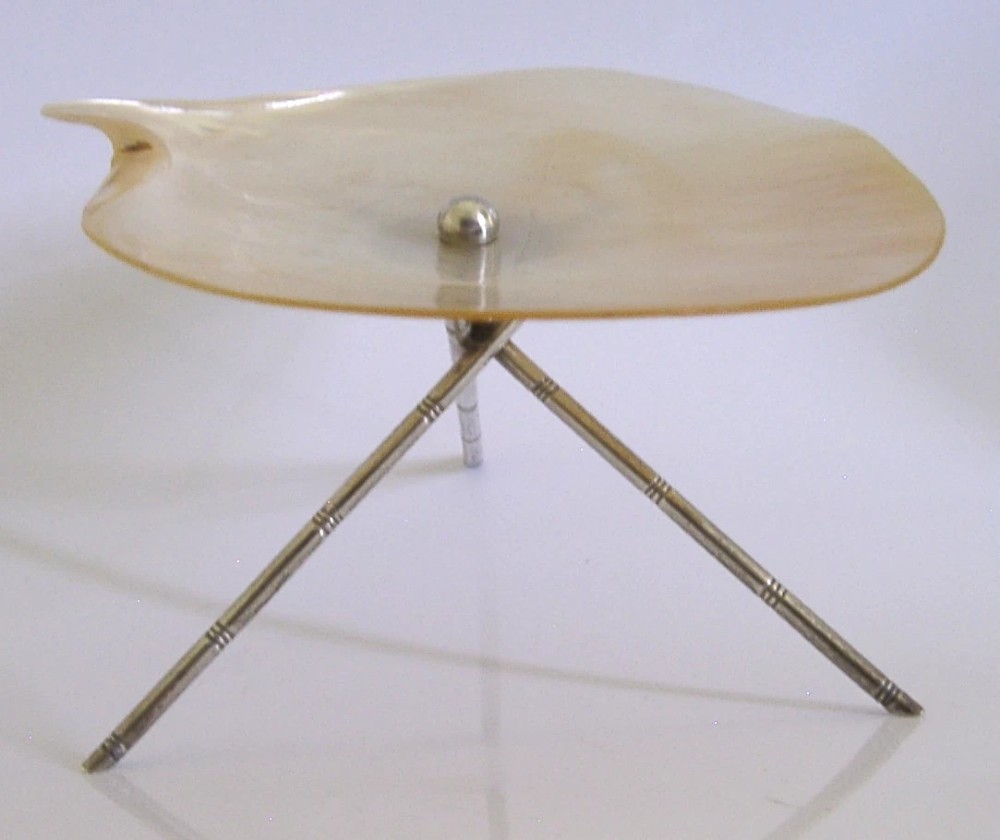 An antique mother-of-pearl shell dish supported on three slender silver tripod legs with a small central silver stud. View IV