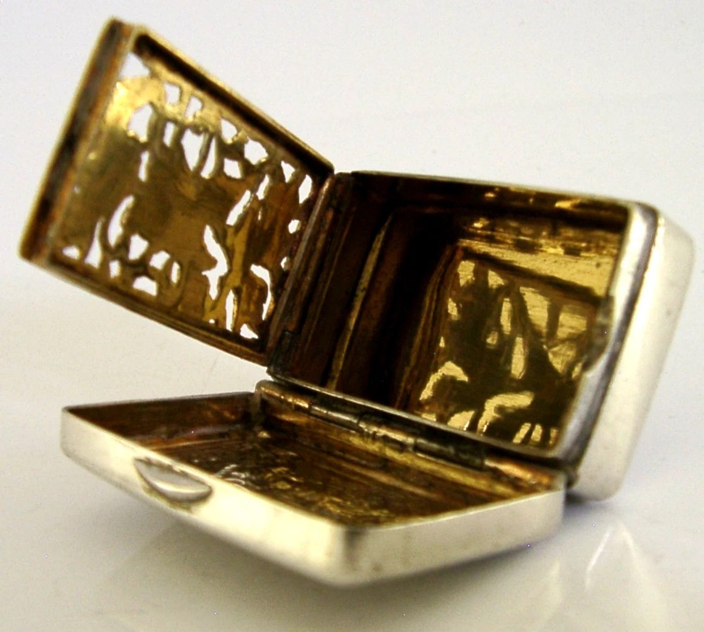 An open nineteenth-century rectangular Chinese export silver vinaigrette box showing a gilded interior with an intricately pierced floral grille. View V