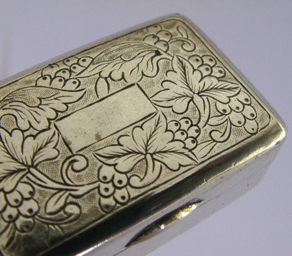 An open nineteenth-century rectangular Chinese export silver vinaigrette box showing a gilded interior with an intricately pierced floral grille. View VI