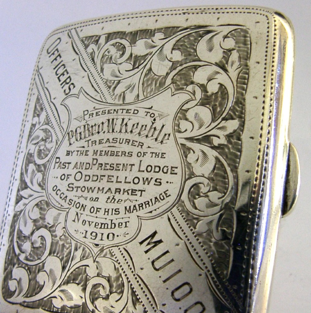 An engraved Edwardian sterling silver cigarette case featuring floral foliage and presentation text for the Independent Order of Oddfellows dated November 1910. View III