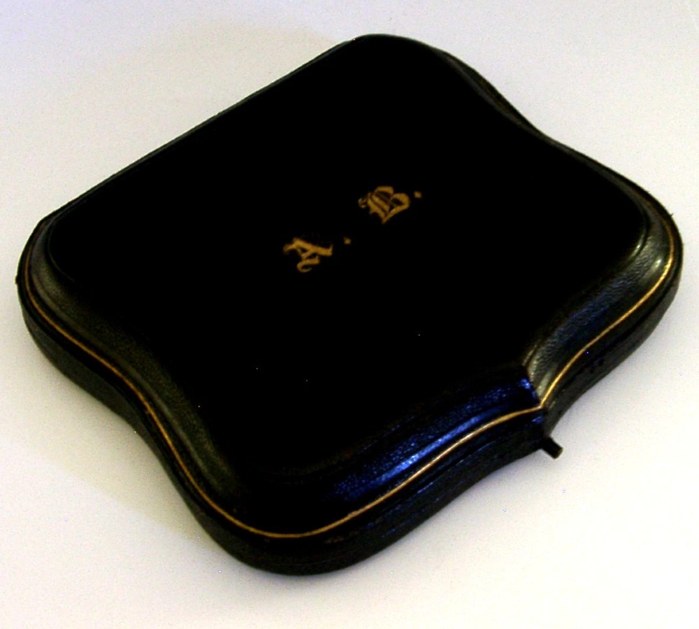 A set of six engraved Victorian sterling silver spoons arranged inside a black fitted presentation case lined with deep purple velvet. View VII
