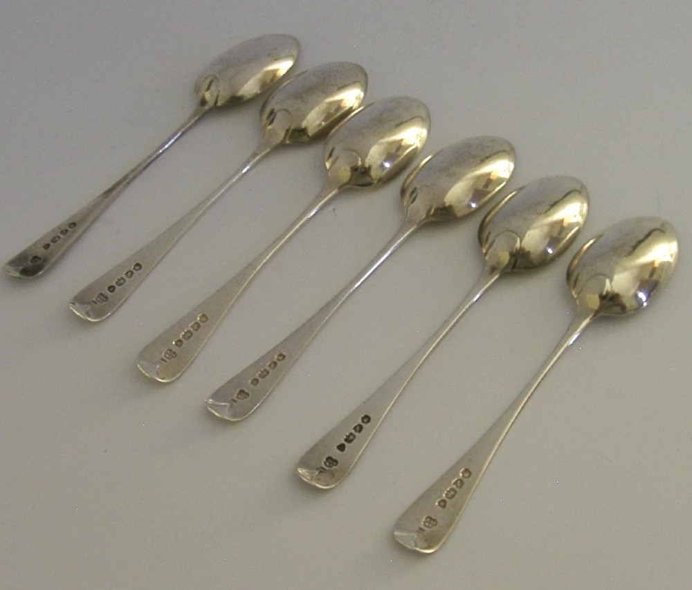 A set of six engraved Victorian sterling silver spoons arranged inside a black fitted presentation case lined with deep purple velvet. View XI
