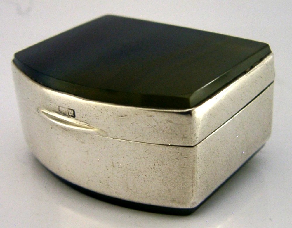 A small hinged sterling silver box featuring an arched lid mounted with a polished blue and yellow banded agate stone. View VIII