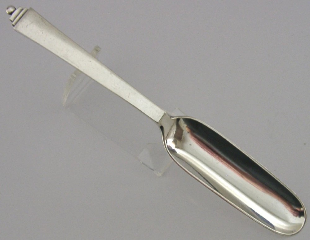 A sterling silver Stilton cheese scoop featuring a tapered handle ending in a stepped pyramid finial.