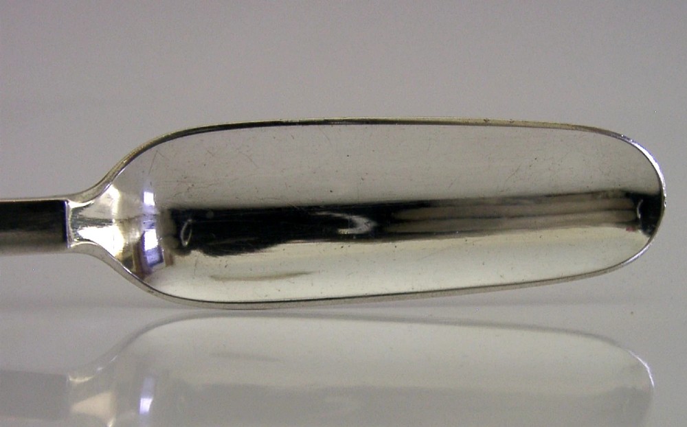 A sterling silver Stilton cheese scoop featuring a tapered handle ending in a stepped pyramid finial. View IV