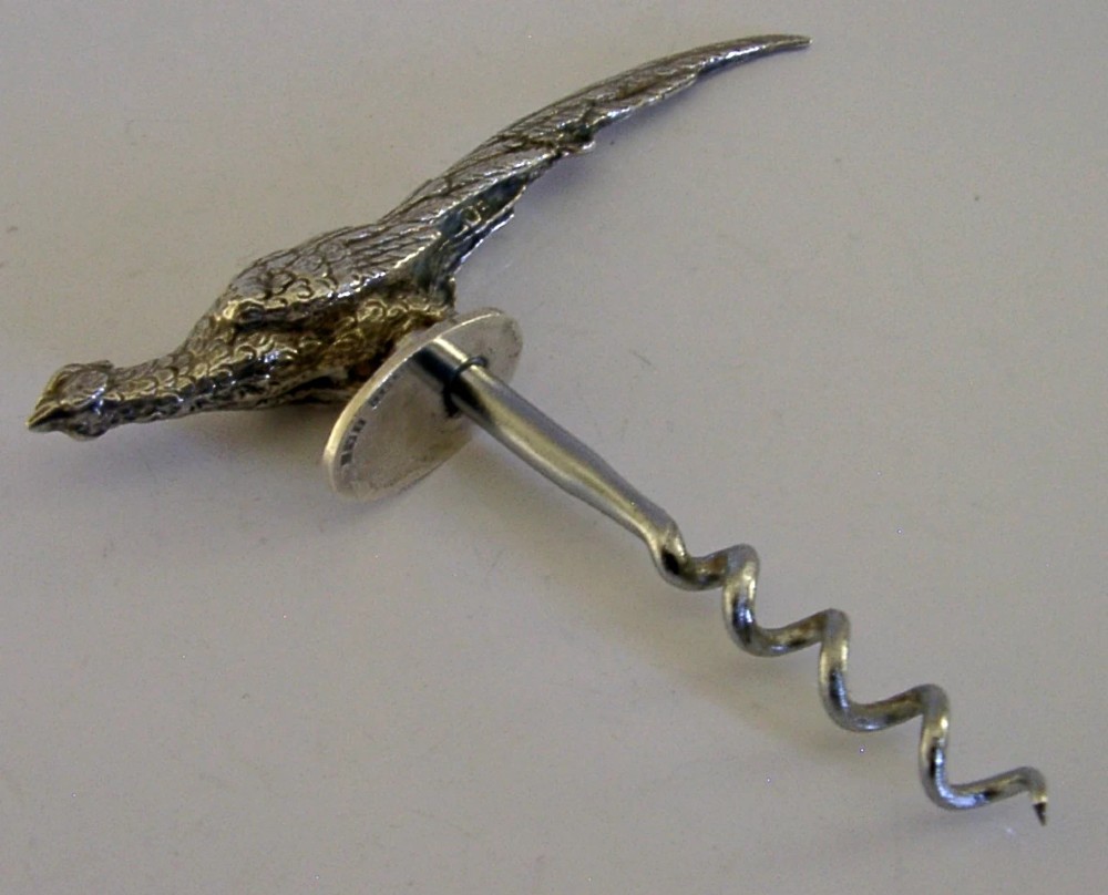 A sterling silver corkscrew featuring a sculpted handle in the shape of a pheasant in flight attached to a steel worm.