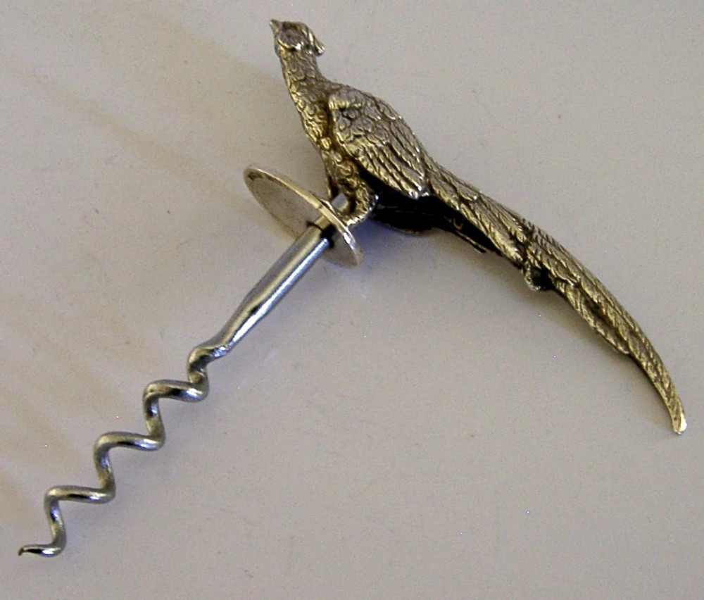 A sterling silver corkscrew featuring a sculpted handle in the shape of a pheasant in flight attached to a steel worm. View IV