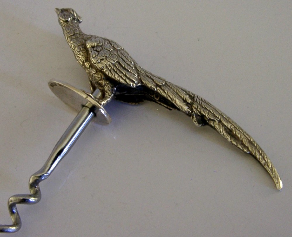 A sterling silver corkscrew featuring a sculpted handle in the shape of a pheasant in flight attached to a steel worm. View VI