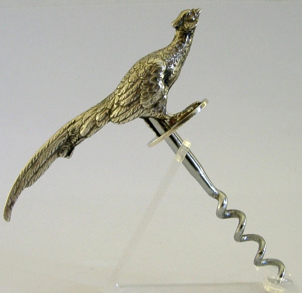 A sterling silver corkscrew featuring a sculpted handle in the shape of a pheasant in flight attached to a steel worm. View VII