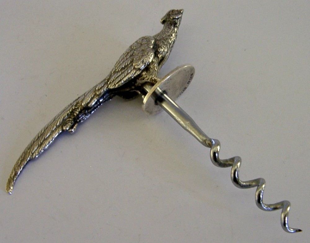A sterling silver corkscrew featuring a sculpted handle in the shape of a pheasant in flight attached to a steel worm. View VIII