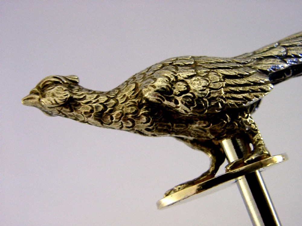 A sterling silver corkscrew featuring a sculpted handle in the shape of a pheasant in flight attached to a steel worm. View IX