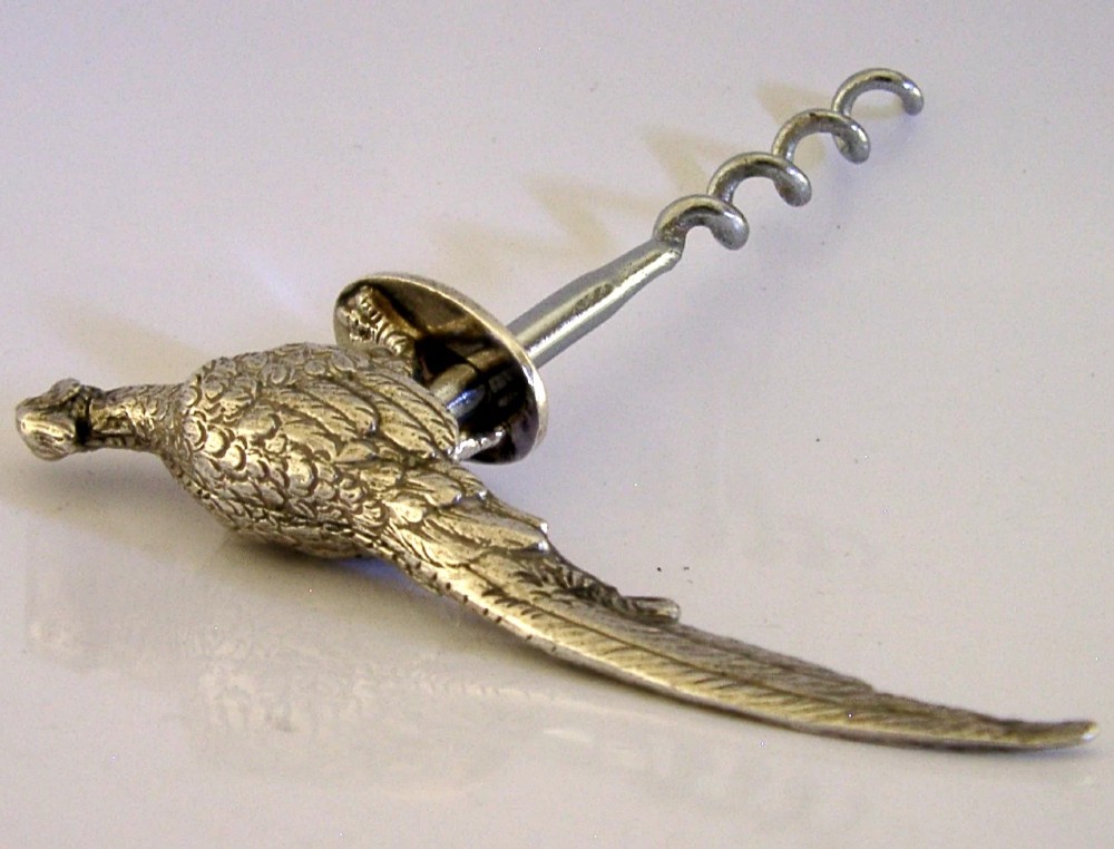 A sterling silver corkscrew featuring a sculpted handle in the shape of a pheasant in flight attached to a steel worm. View XI