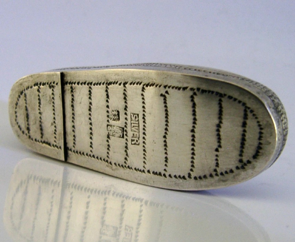 An antique Chinese export silver novelty pin cushion formed in the shape of a traditional slipper, featuring chased bat motifs and textured surface decoration. View VIII