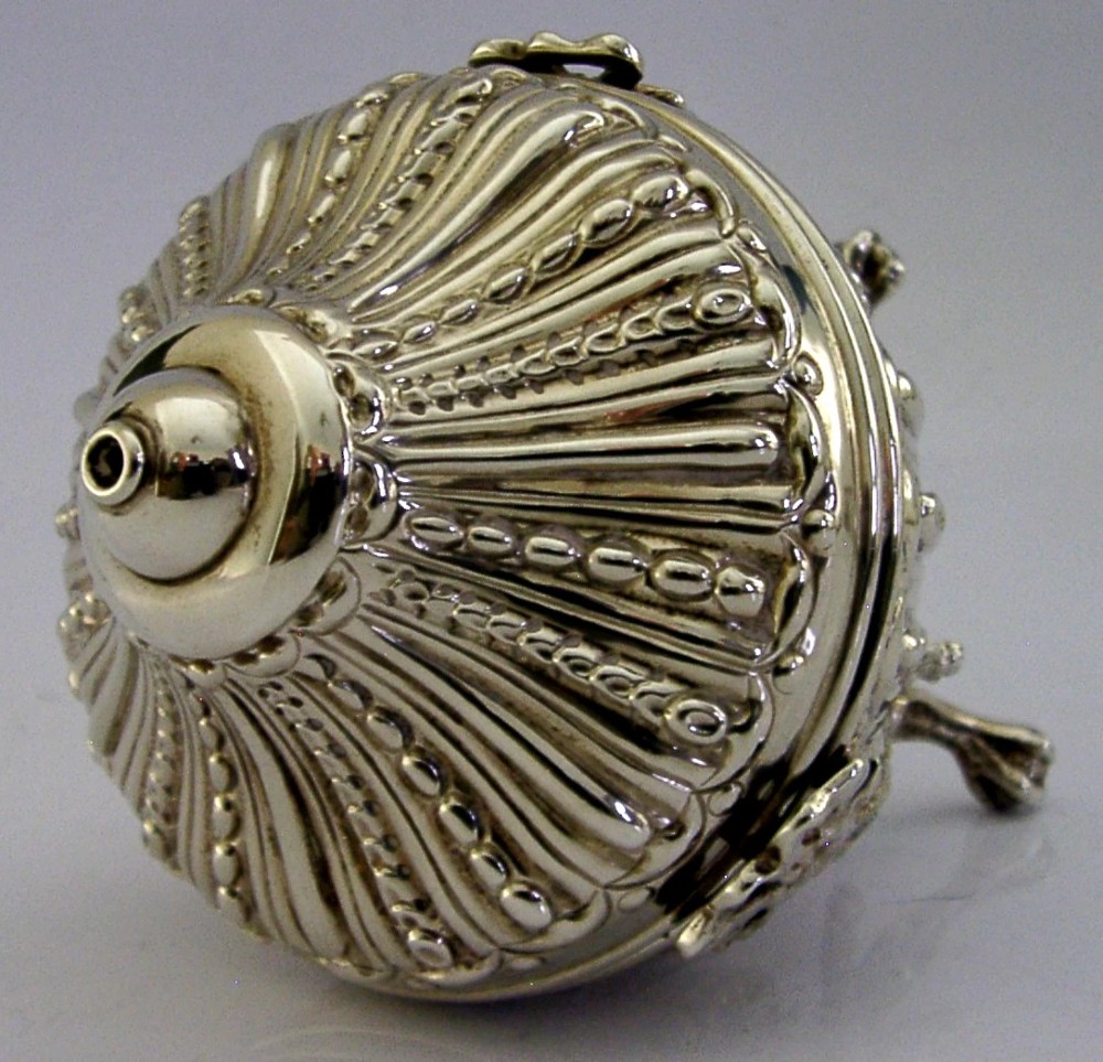 A Victorian sterling silver string box featuring detailed repousse fluting, a domed lid, and three ornate scrolled feet. View III