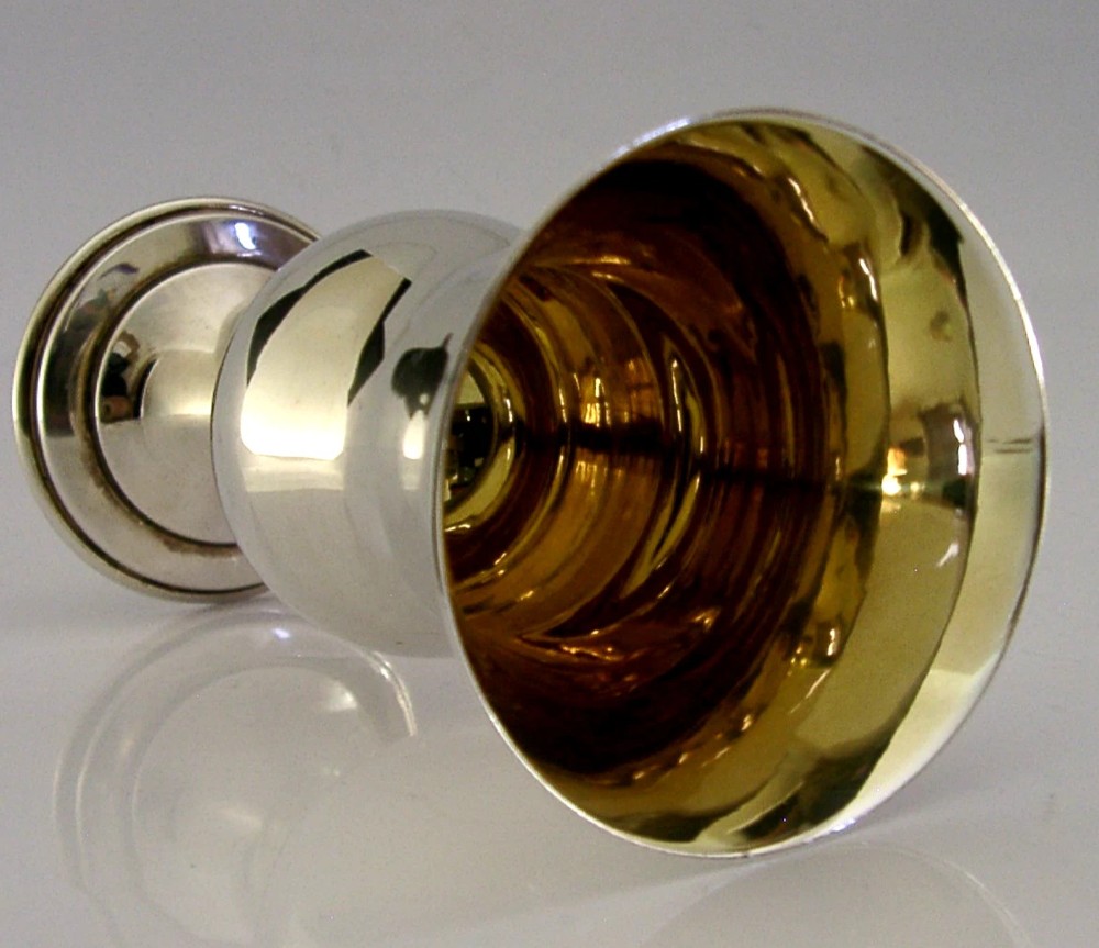 A sterling silver wine goblet featuring a bulbous bowl with a flared rim, a gilt interior, a short turned stem, and a stepped circular foot. View VI