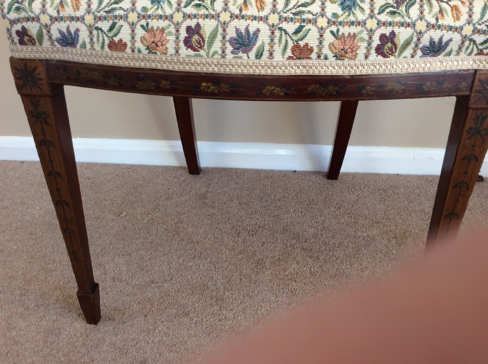 A Georgian open elbow chair with dark wood frame featuring hand-painted floral and musical motifs, an X-shaped back splat with central roundel, and a floral patterned upholstered seat. View V