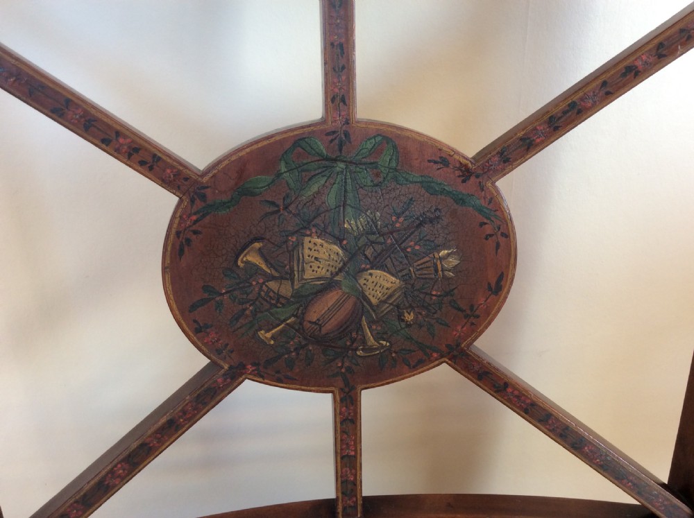 A Georgian open elbow chair with dark wood frame featuring hand-painted floral and musical motifs, an X-shaped back splat with central roundel, and a floral patterned upholstered seat. View VII