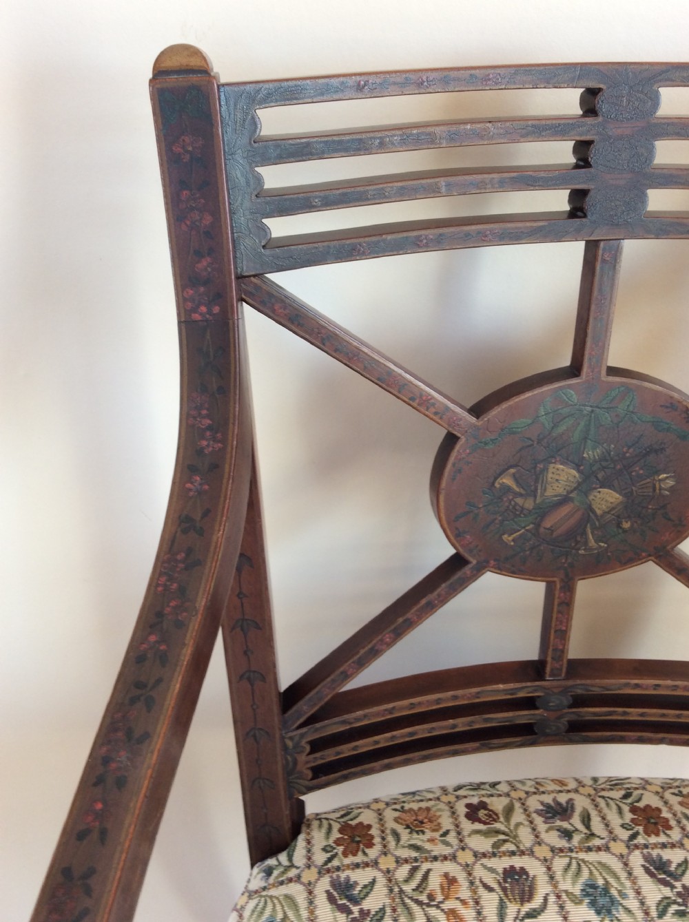 A Georgian open elbow chair with dark wood frame featuring hand-painted floral and musical motifs, an X-shaped back splat with central roundel, and a floral patterned upholstered seat. View VIII