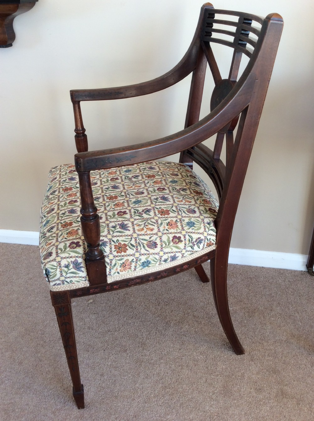 A Georgian open elbow chair with dark wood frame featuring hand-painted floral and musical motifs, an X-shaped back splat with central roundel, and a floral patterned upholstered seat. View X