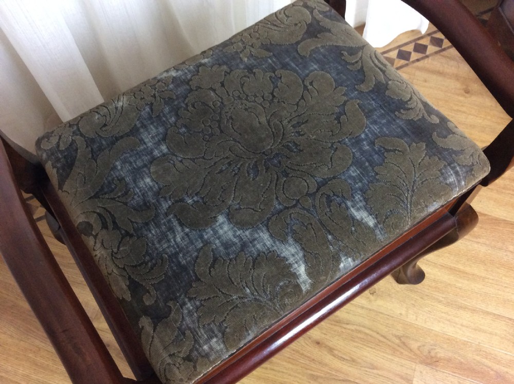 An Edwardian mahogany piano stool with raised side handles, satinwood line inlay, cabriole legs, and a dark patterned velvet upholstered seat. View II