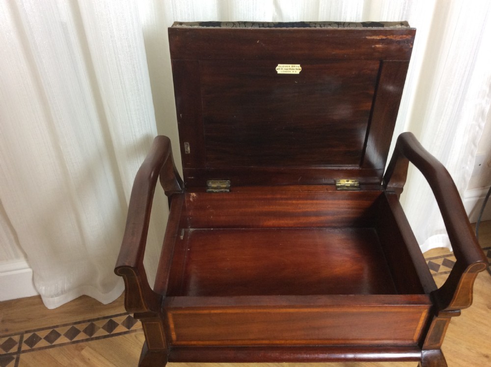 An Edwardian mahogany piano stool with raised side handles, satinwood line inlay, cabriole legs, and a dark patterned velvet upholstered seat. View VIII