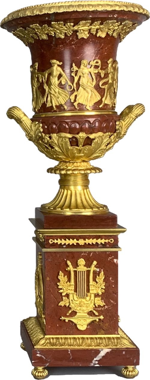 A pair of French Empire style red marble urns featuring gilded bronze classical figure reliefs and mounted on square marble pedestals with lyre details. View VIII