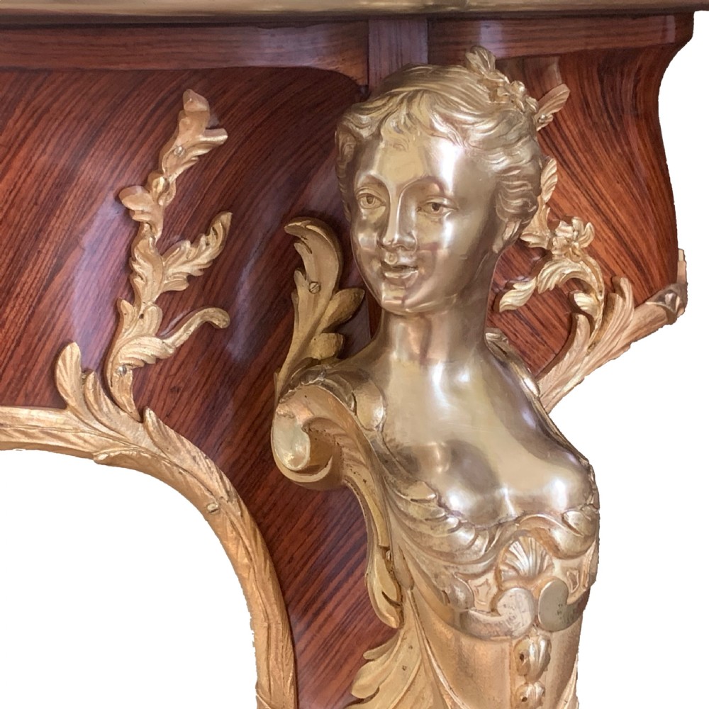 A serpentine kingwood and rosewood centre table featuring cabriole legs with decorative ormolu female bust mounts and gilt sabots. View IX