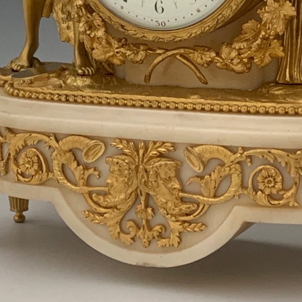 A Louis XVI style French ormolu and white marble mantel clock depicting two sculptural classical female figures flanking a circular white enamel dial. View VIII