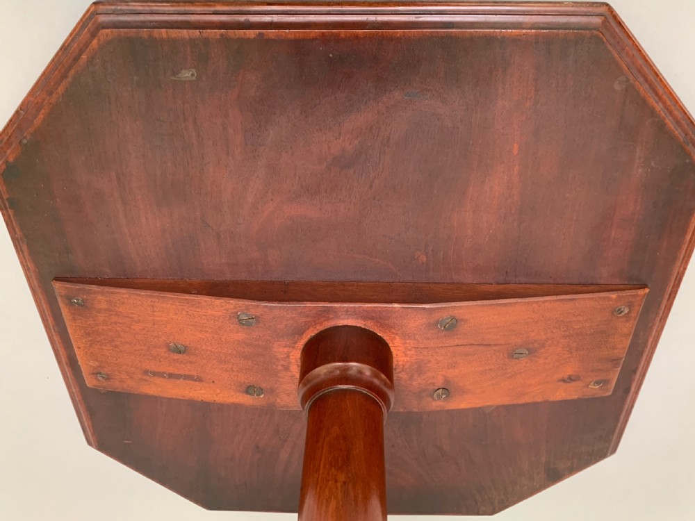 An antique Victorian mahogany side table featuring an octagonal top on a turned central pedestal with a quadruped base. View VII