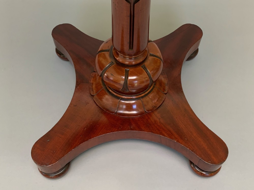 An antique Victorian mahogany side table featuring an octagonal top on a turned central pedestal with a quadruped base. View VIII