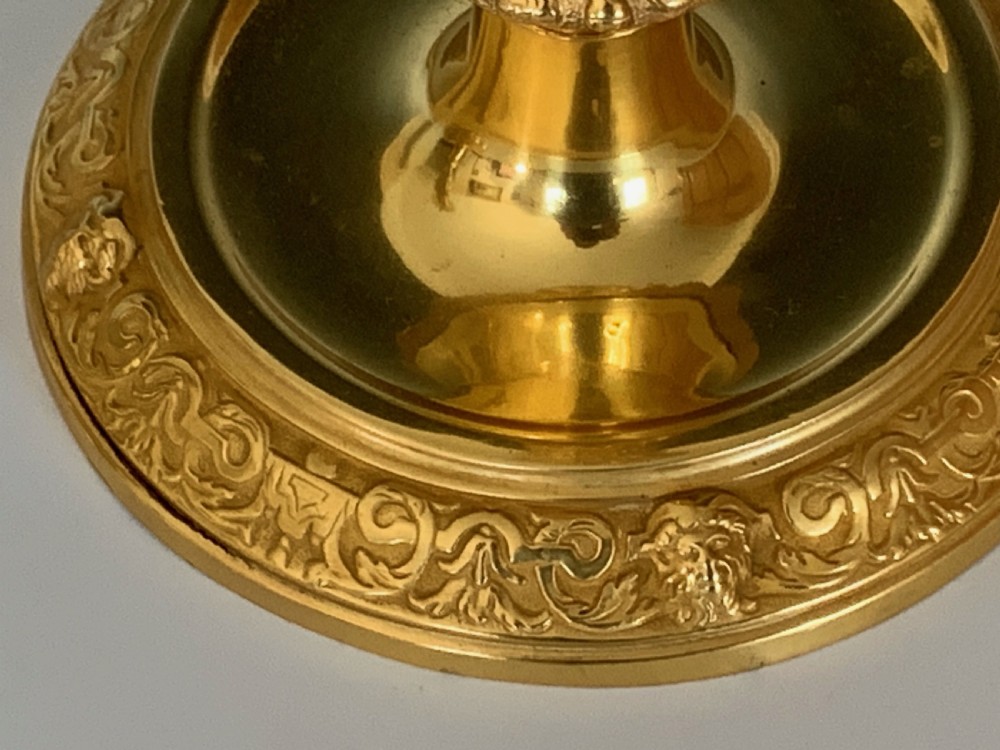 A pair of French Regence gilt bronze candlesticks featuring tapered columns decorated with allegorical term busts and circular chased bases. View VI