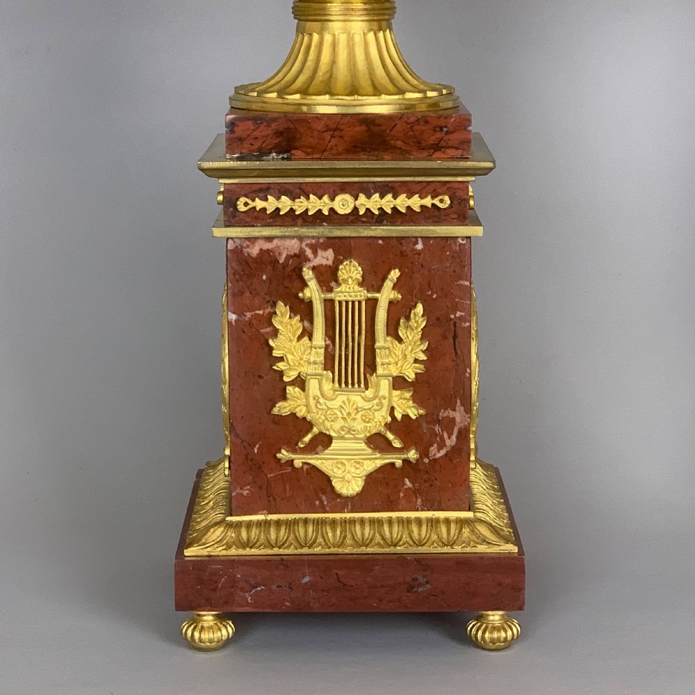 A pair of red marble urns featuring gilt bronze mounts, classical relief friezes of dancing figures, and pedestal bases decorated with lyres. View III