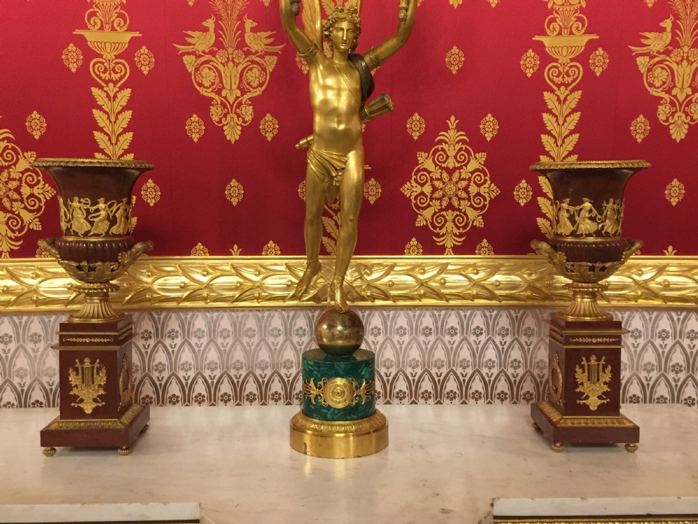 A pair of red marble urns featuring gilt bronze mounts, classical relief friezes of dancing figures, and pedestal bases decorated with lyres. View VIII