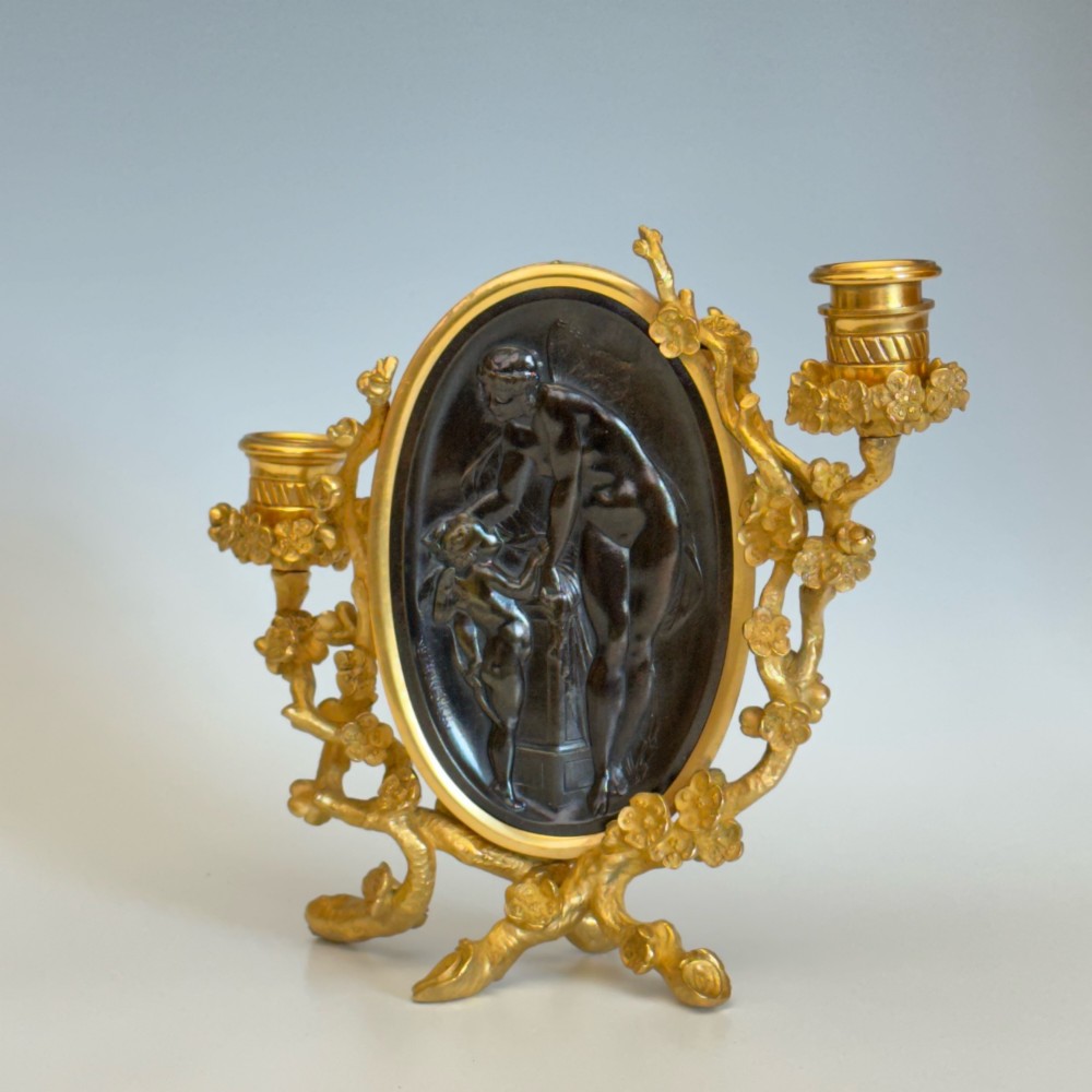 A French 19th-century gilt bronze table frame featuring a central oval classical relief medallion flanked by two candelabra arms with organic floral branching. View II