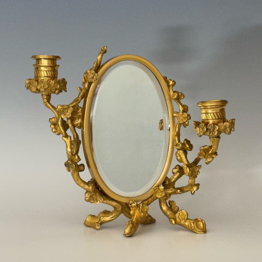A French 19th-century gilt bronze table frame featuring a central oval classical relief medallion flanked by two candelabra arms with organic floral branching. View III