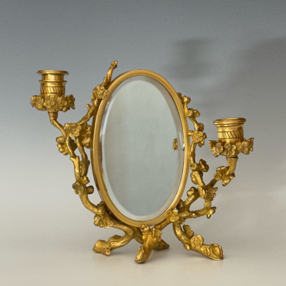A French 19th-century gilt bronze table frame featuring a central oval classical relief medallion flanked by two candelabra arms with organic floral branching. View IV