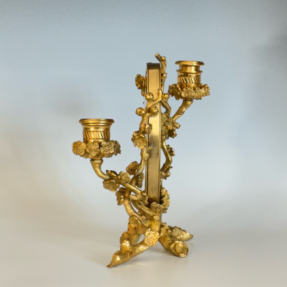 A French 19th-century gilt bronze table frame featuring a central oval classical relief medallion flanked by two candelabra arms with organic floral branching. View V