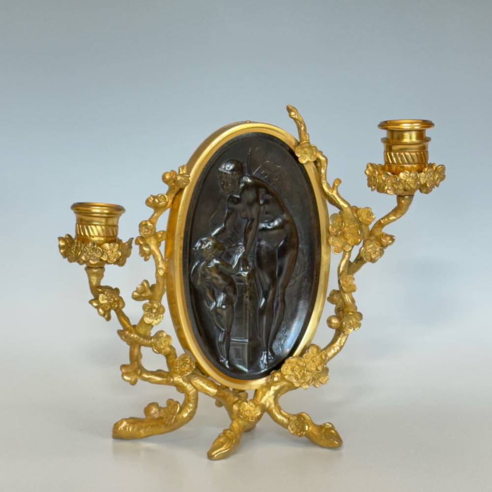 A French 19th-century gilt bronze table frame featuring a central oval classical relief medallion flanked by two candelabra arms with organic floral branching. View VI