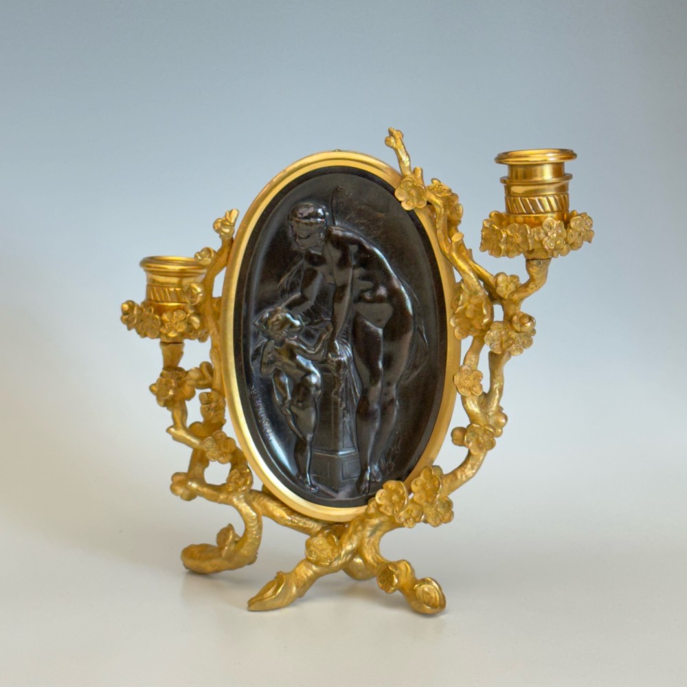 A French 19th-century gilt bronze table frame featuring a central oval classical relief medallion flanked by two candelabra arms with organic floral branching. View VII