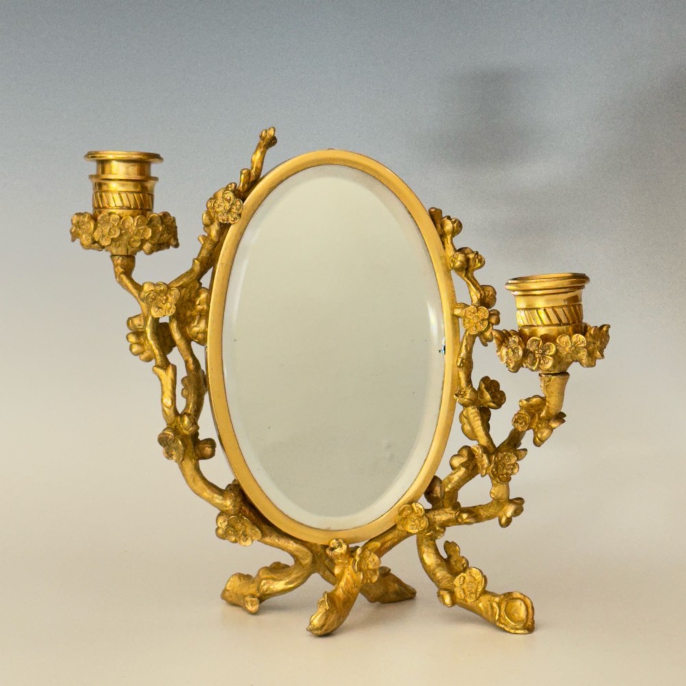 A French 19th-century gilt bronze table frame featuring a central oval classical relief medallion flanked by two candelabra arms with organic floral branching. View IX