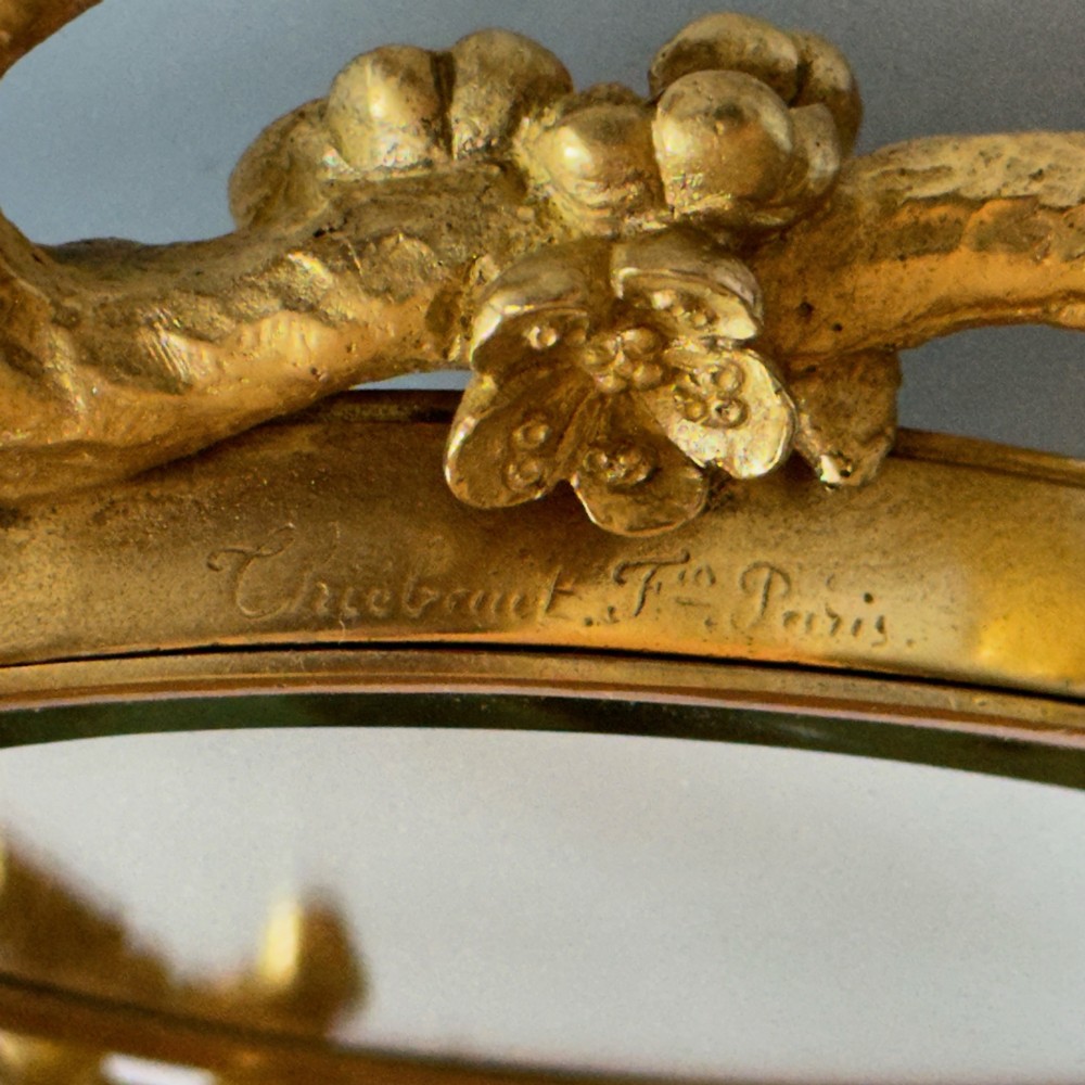 A French 19th-century gilt bronze table frame featuring a central oval classical relief medallion flanked by two candelabra arms with organic floral branching. View X